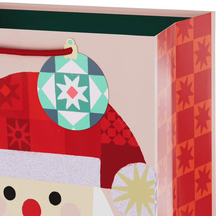 9.6-inch medium Christmas gift bag featuring a glittery quilted Santa design with an included gift tag.