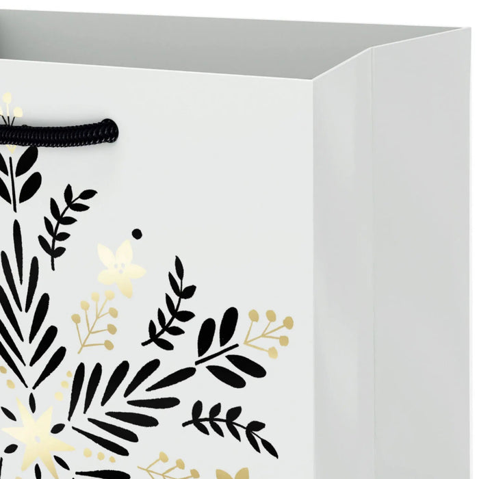 6.5-inch small Christmas gift bag featuring gold snowflakes on a black background.