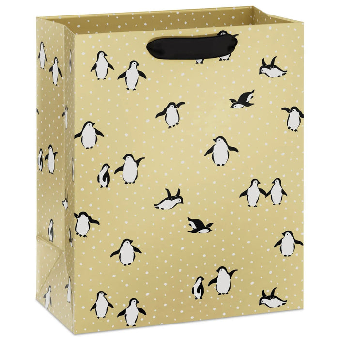 9.6-inch medium Christmas gift bag featuring penguins on a festive gold background.