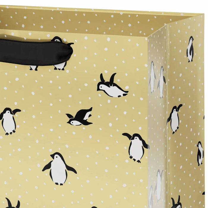 9.6-inch medium Christmas gift bag featuring penguins on a festive gold background.