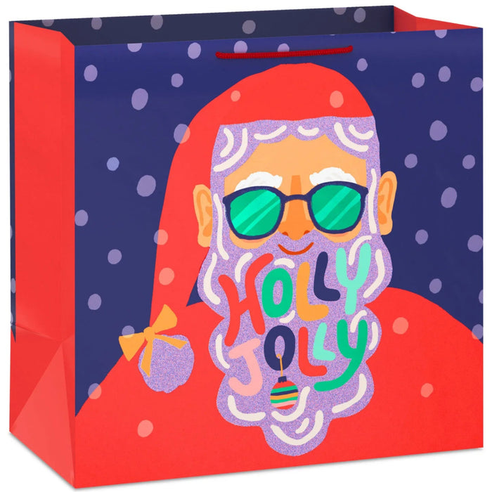15-inch extra-deep Christmas gift bag featuring a glittery Santa design and “Holly Jolly” theme.