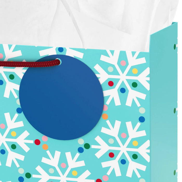 13-inch large blue Christmas gift bag featuring colorful rainbow snowflakes with tissue paper.