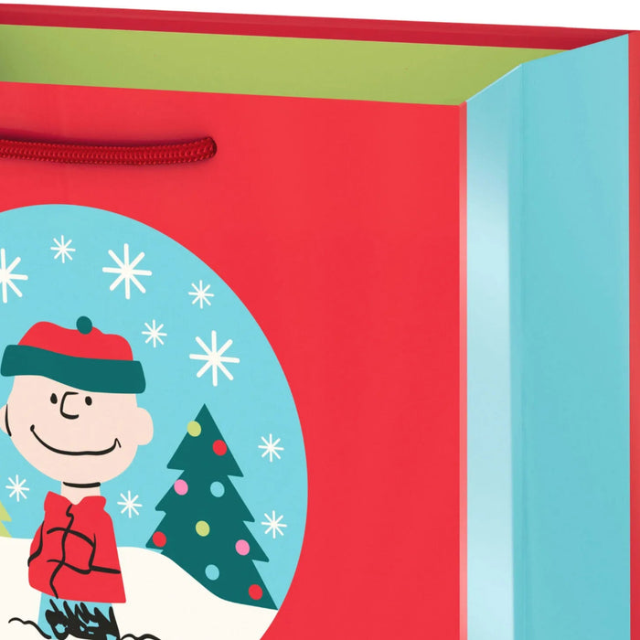 9.6-inch medium Christmas gift bag featuring a Peanuts® Charlie Brown snow globe design