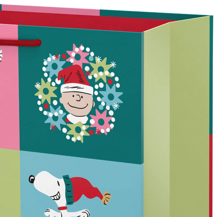 15.5-inch extra-large Christmas gift bag featuring Snoopy and Charlie Brown in a festive grid design.