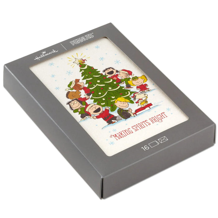 Hallmark Peanuts Gang Christmas cards featuring Snoopy and friends caroling around a decorated Christmas tree, pack of 16.