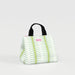 A white lunch bag with a green leaf pattern, showcasing a stylish and eco-friendly design for carrying meals.