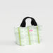 A white tote bag adorned with green leaves, emphasizing a fresh and botanical aesthetic.