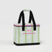 A stylish lunch bag featuring a white and pink color scheme, decorated with green leaves for a fresh look.