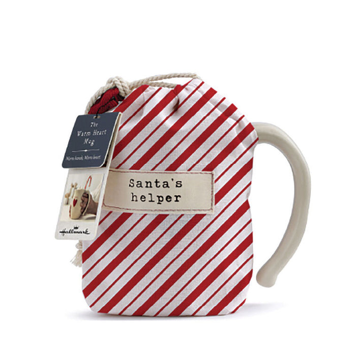 Red and white striped mug with 'Santa's helper' text and a tag on a white background