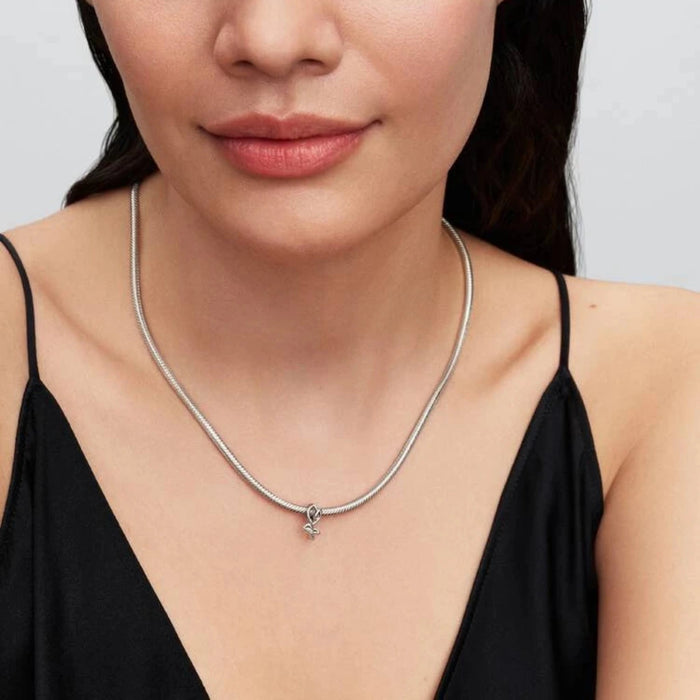 Silver necklace with a tulip-shaped charm on a women