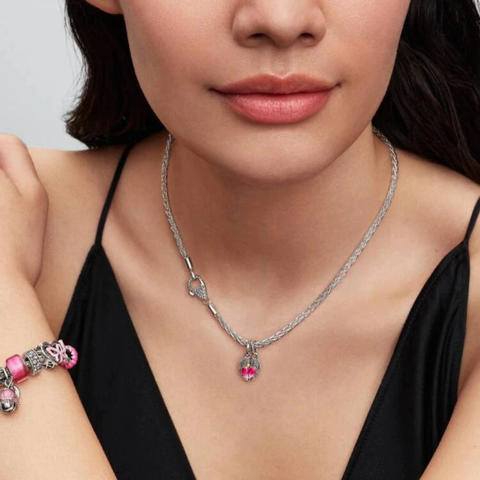 Silver bracelet and necklace with a tree-shaped charm on a women