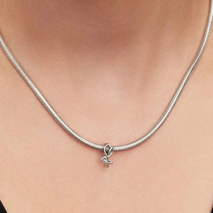 Silver necklace with a tulip-shaped charm on a women