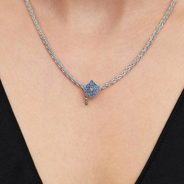 Silver necklace with a graduation cap charm on a women