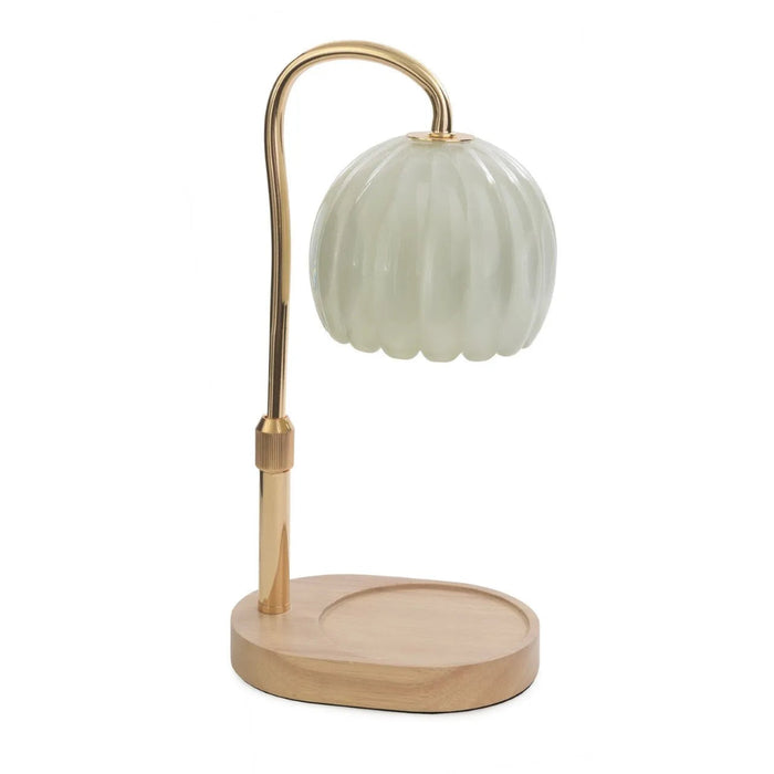 Desk  dandle warmer with a green glass shade and gold metal arm on a white background