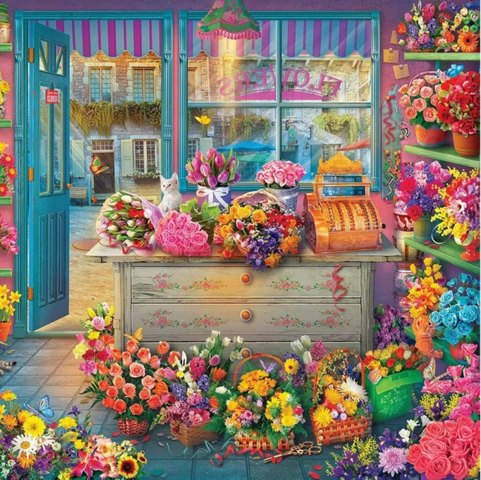 Colorful flower shop interior with flowers and a cash register.
