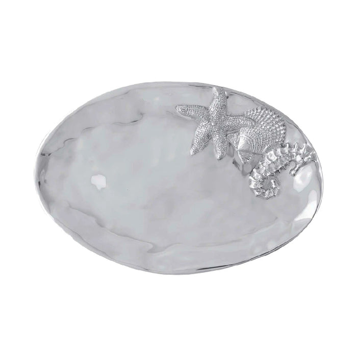 A silver plated oval tray displaying a starfish and a shell, elegantly arranged for decorative purposes.