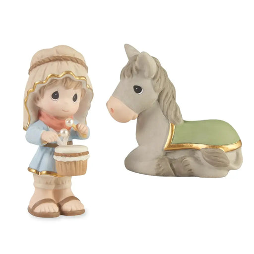 A Precious Moments figurine set featuring a baby girl holding a cupcake and a gray horse with a green blanket, both on a white background.