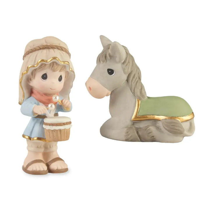 A Precious Moments figurine set featuring a baby girl holding a cupcake and a gray horse with a green blanket, both on a white background.