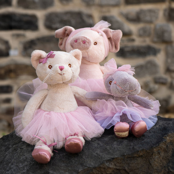 A stuffed feline in a vibrant tutu skirt, positioned cutely with a friendly demeanor.