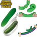 Green jumbo squishy pickle toy with hands interacting with it on a white background