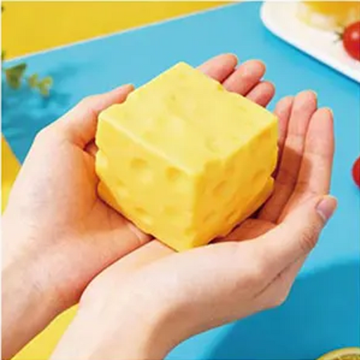 Yellow sponge held in hands with a colorful background