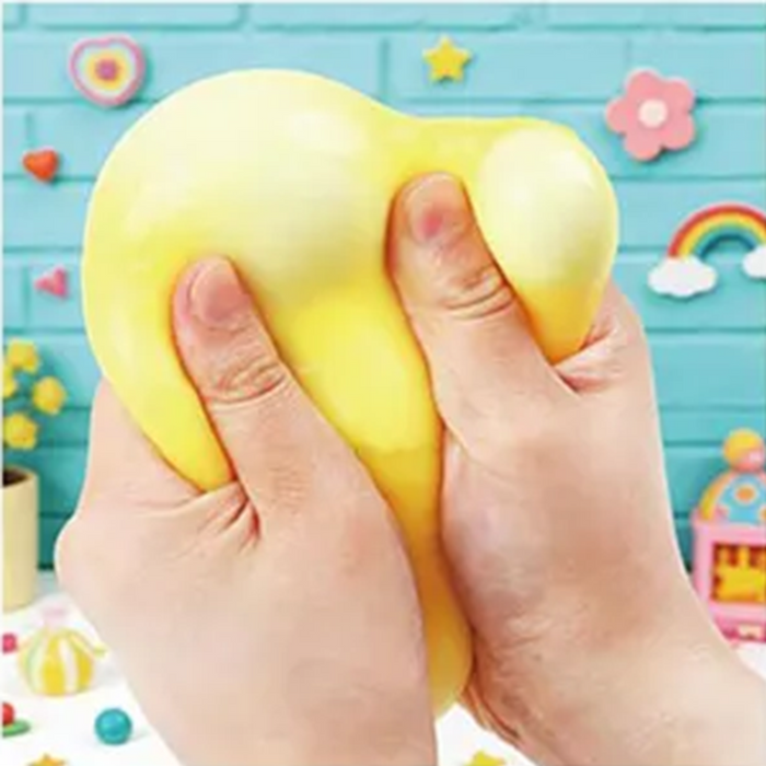Yellow stress ball being held by a hand with a colorful background