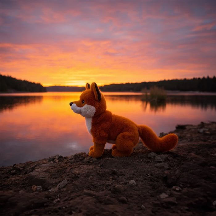 A charming stuffed fox sitting on a white background, featuring detailed stitching and a playful pose.