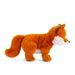 A cute stuffed animal fox resting on a white surface, highlighting its vibrant colors and cuddly appearance.