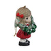 Decorative figurine of a girl holding a Christmas wreath on a plain background