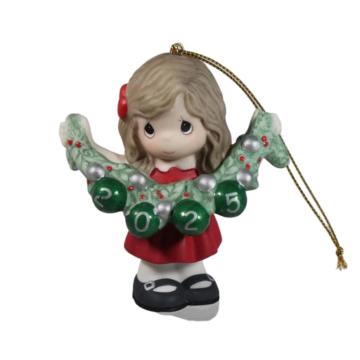 Christmas ornament of a girl with a wreath and numbers on a plain background