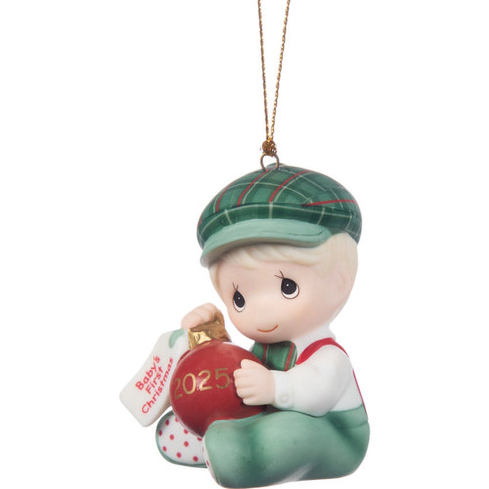 Christmas ornament of a child holding a red ball with '2025' on it, wearing a green cap.