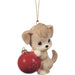 Dog ornament holding a red ball with '2025' on it, hanging from a string.