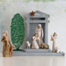 Nativity scene with figures and a tree on a white background