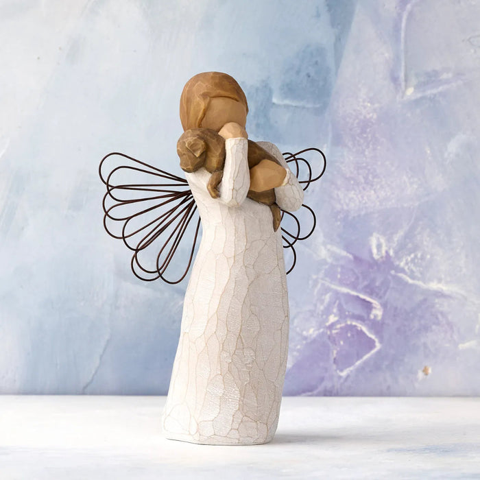 Angel figurine with a heart on a textured light blue background