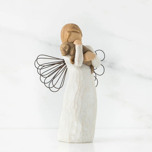 Angel figurine holding a child on a white background