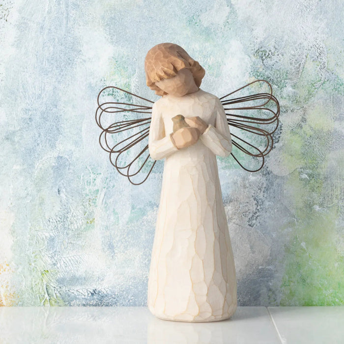 Angel figurine with wire wings on a textured light background