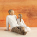 Figurine of a Father and Daughter Sitting together  with a wooden background 