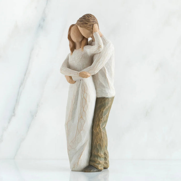 Statue of a couple embracing on a white background