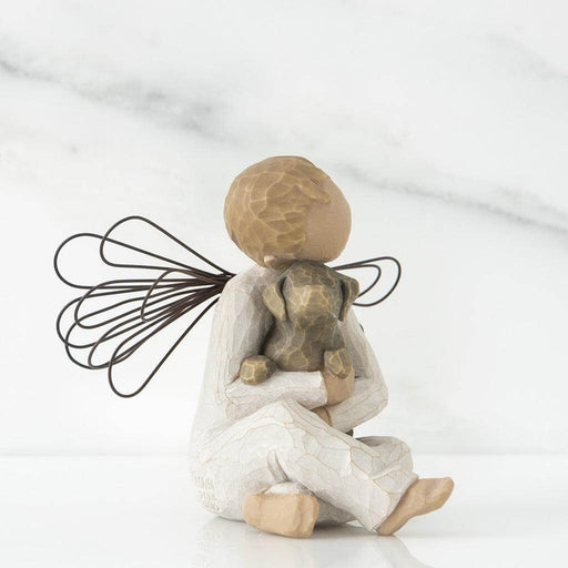 angel figurine holding a dog on a white background