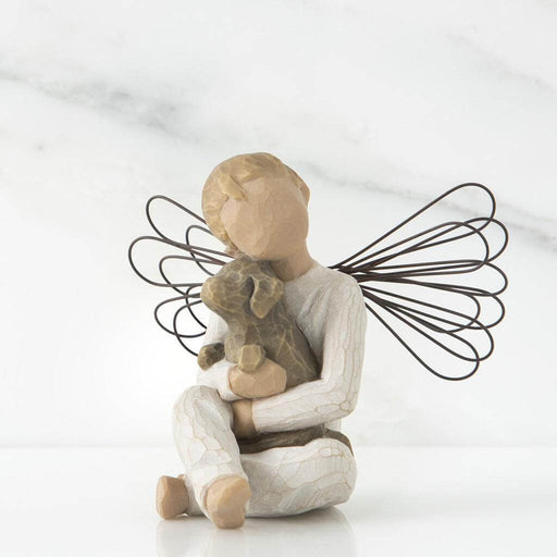 Angel figurine holding a dog with wire wings on a white background