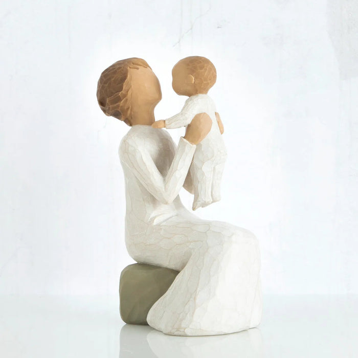 Willow Tree Grandmother figurine holding a baby on a white background 