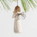 Decorative angel ornament  holding a child with a wire wings against a light background