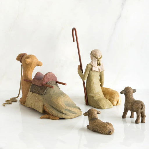 Set of rustic nativity scene figurines on a white background