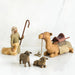 nativity scene figures including a shepherd, two sheep, and a camel on a white background