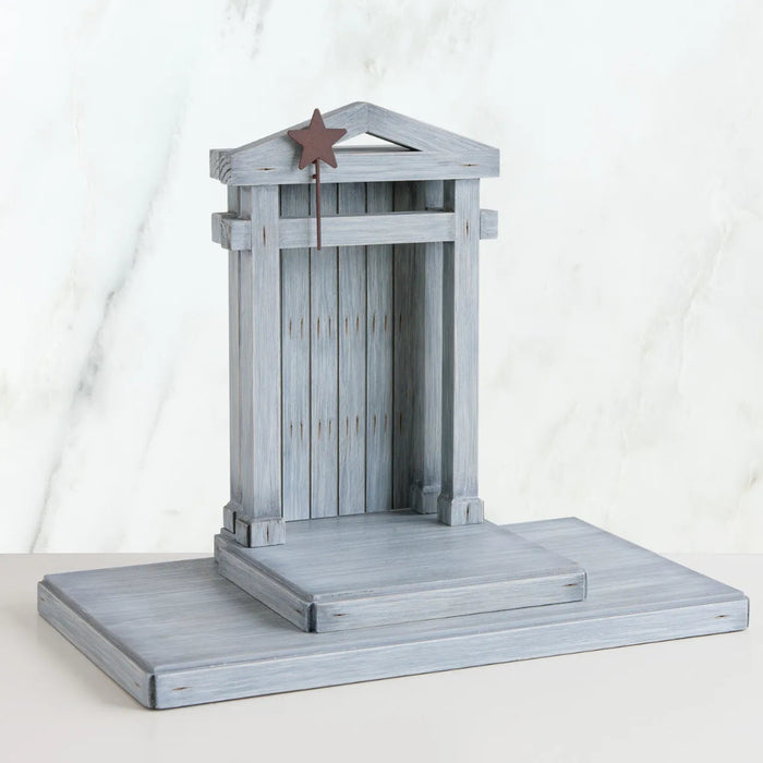 Side view of Decorative Creche with a star on a white background