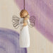 Angel figurine with wire wings against a soft, multicolored background