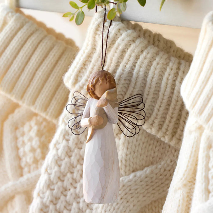angel ornament hanging on a knitted blanket