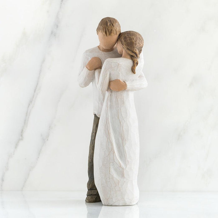 Statue of a couple embracing on a white background