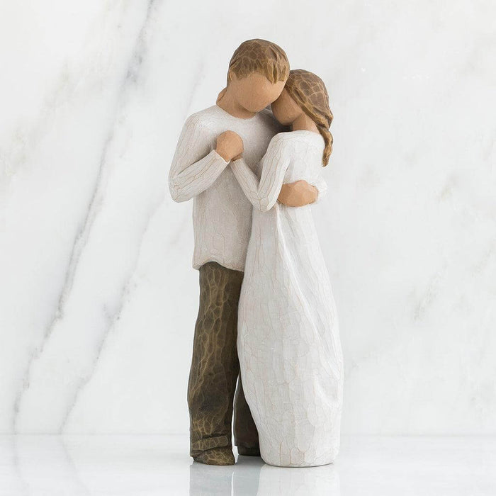 Statue of a couple embracing on a white background