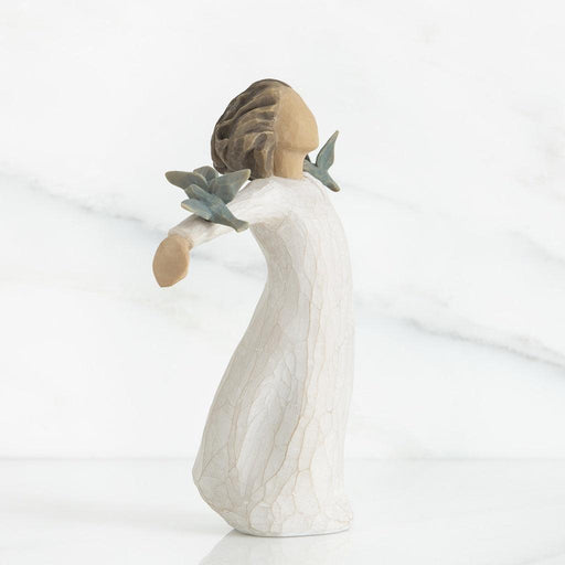 Decorative figurine with birds resting on her outstretched arms on a white background